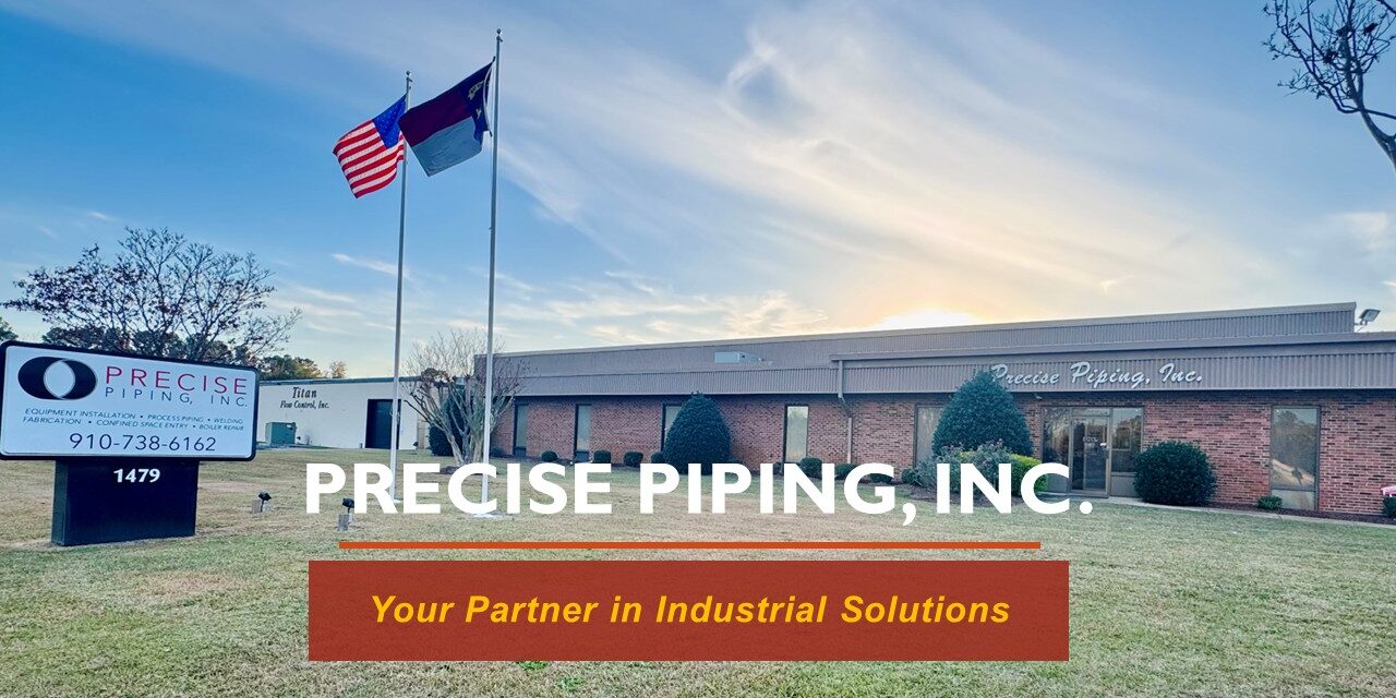 Exterior of Precise Piping, Inc. building with flags and signage.